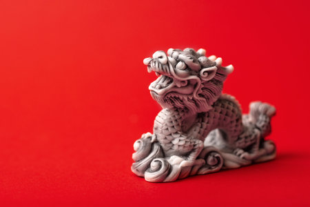 Gray dragon statue on a red background. The symbol of 2024. Happy Chinese New Year.の写真素材