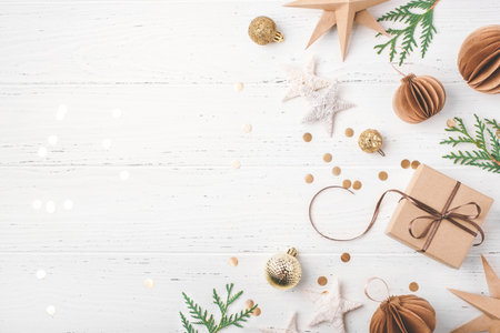 Festive Christmas background with gift box and Christmas decorations on white wooden table. Top view. Copy space for text.の写真素材