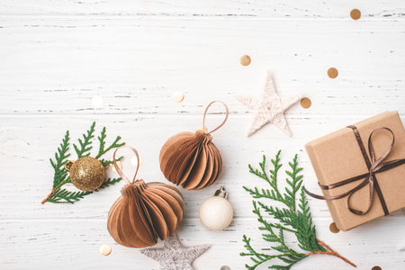 Festive Christmas background with gift box and Christmas decorations on white wooden table. Top view.の写真素材