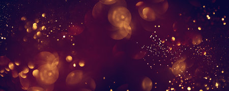 Golden abstract bokeh on black background. Celebrating Christmas, New Year or other holidays.の写真素材