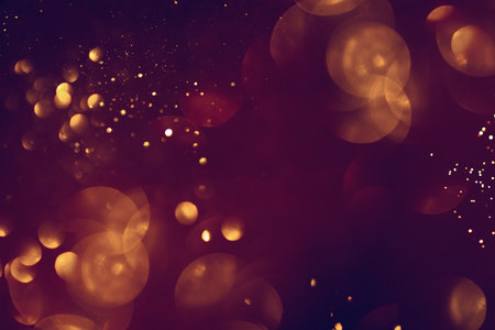 Golden abstract bokeh on black background. Celebrating Christmas, New Year or other holidays.の写真素材