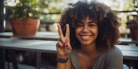 Happy smiling young woman sitting in a cafe.の素材