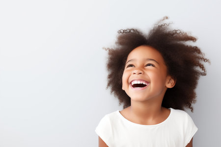 Little laughing girl on a white background.の素材
