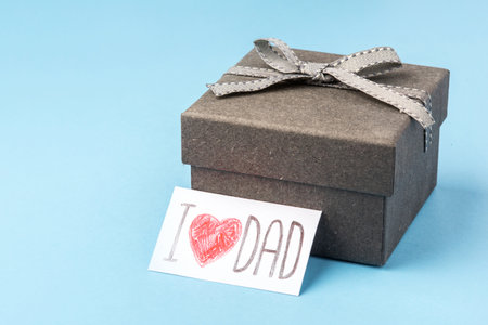 A gray gift box with a Fathers Day greeting card.の写真素材