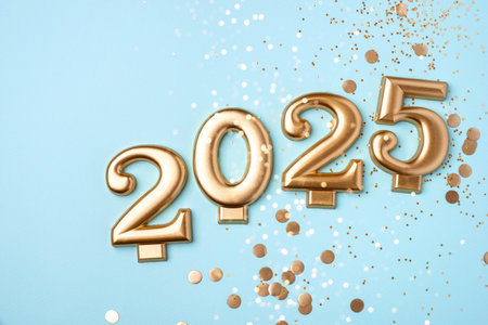 Golden 2025 on a blue color background with confetti and bokeh lights. Happy New Year 2025 is coming concept. Top view.の写真素材