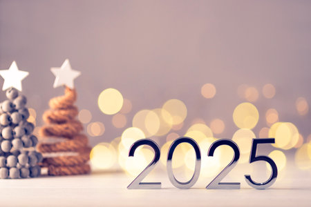 Metal numbers 2025 on a white table with Christmas trees and bokeh lights. Happy New Year 2025 is coming concept.の写真素材