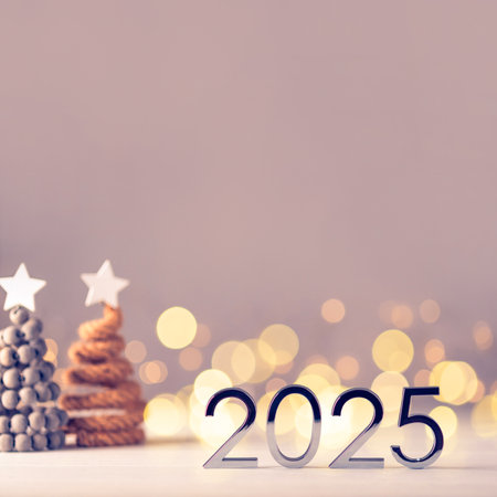 Metal numbers 2025 on a white table with Christmas trees and bokeh lights. Happy New Year 2025 is coming concept.の写真素材