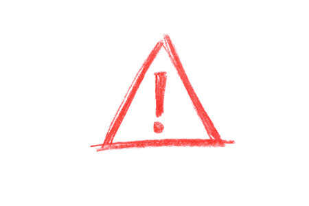 A red pencil sketch of an attention sign isolated on white backgroundの写真素材