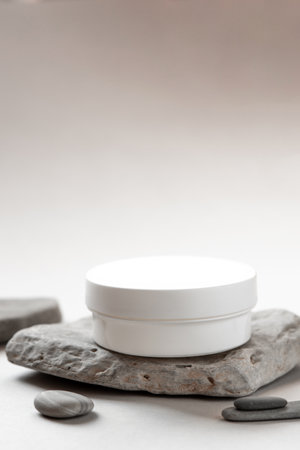 Minimalist Skincare Cream Jar on Natural Stone with Soft Neutral Backgroundの写真素材