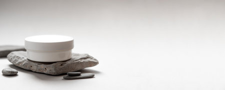 Minimalist Skincare Cream Jar on Natural Stone with Soft Neutral Backgroundの写真素材