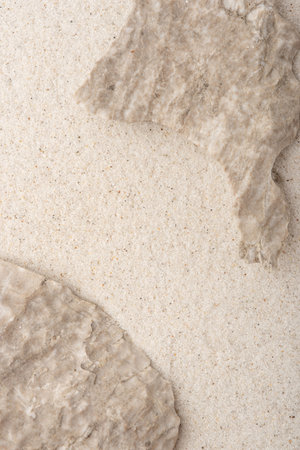 Natural cosmetic background for product presentation. Beige rocks on the sand. Top view.の写真素材