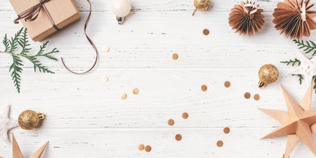 Festive Christmas background with gift box and Christmas decorations on white wooden table. Top view. Copy space for text.の写真素材