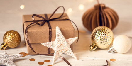 Christmas gift box and decorations on white wooden table. Front view.の写真素材