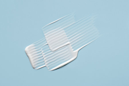 Smear of cosmetic cream on a blue background.