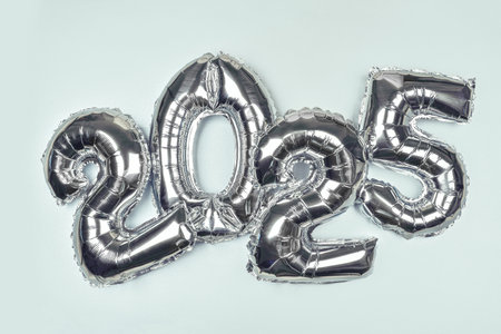 2025 Silver Balloon Numbers on blue background. Festive New Year Celebration Themeの写真素材