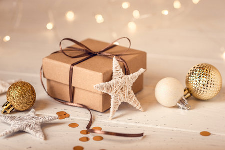 Christmas gift box and decorations on white wooden table.の写真素材
