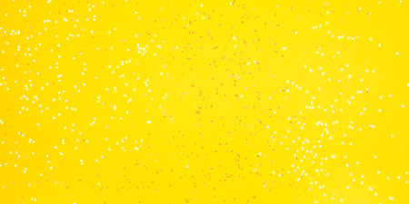 Tiny pearl stars on yellow background. Flat lay, top view.の写真素材