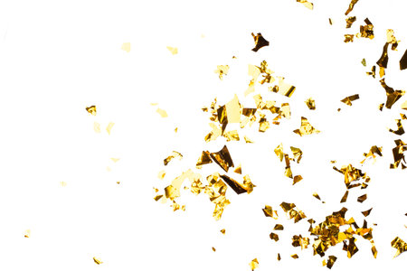 Golden Foil Confetti Scattered on White Backgroundの写真素材