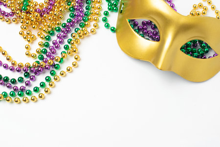 Mardi Gras beads and mask on white backgroundの写真素材