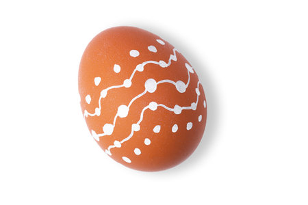 One Easter egg is a natural brown color with a minimalistic white pattern isolated on a white background.の写真素材