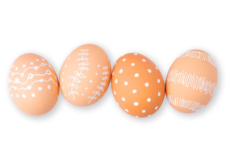 Natural Easter eggs with white minimalist patterns (hearts, dots, and lines) isolated on a white backgroundの写真素材