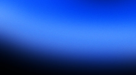 A vibrant gradient background with vibrant blue hues blending seamlessly into black. Banner with grain textureの写真素材