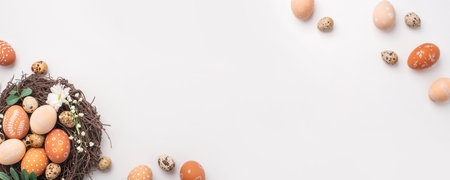 Easter nest with hand-painted eggs and quail eggs on a light background. A rustic spring composition...