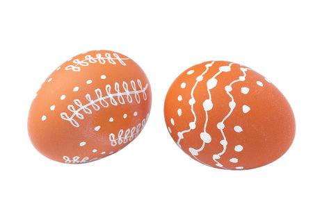 Natural brown Easter eggs with white minimalist patterns isolated on a white backgroundの写真素材