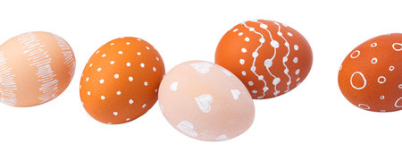 Natural brown Easter eggs with white minimalist patterns (hearts, dots, and lines) isolated on a white backgroundの写真素材