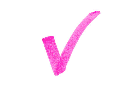 A hand-drawn pink checkmark on a white backgroundの写真素材
