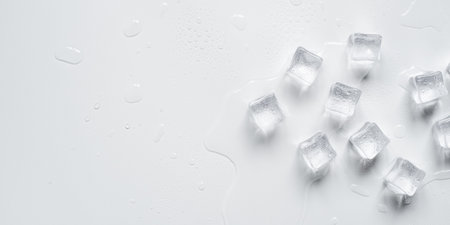 Melting ice cubes in a splash of water on a white backgroundの写真素材