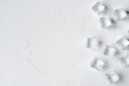 Melting ice cubes in a splash of water on a white backgroundの写真素材