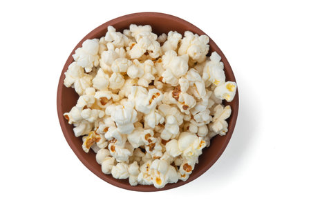 Tasty salty popcorn in a bowl isolated on a white backgroundの写真素材