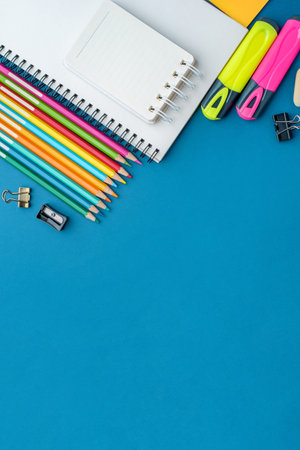 Bright school supplies on a blue background. The back to school conceptの写真素材