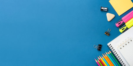 Bright school supplies on a blue background. The back to school conceptの写真素材