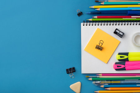 Bright school supplies on a blue background. The back to school conceptの写真素材