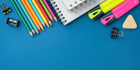Bright school supplies on a blue background. The back to school conceptの写真素材