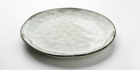 Empty gray textured plate on white backgroundの写真素材