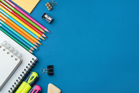 Bright school supplies on a blue background. The back to school conceptの写真素材