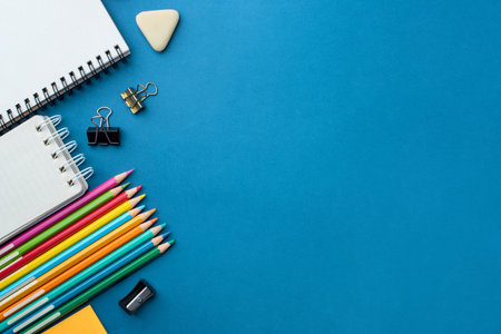 Bright school supplies on a blue background. The back to school conceptの写真素材