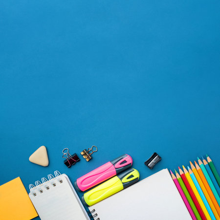 Bright school supplies on a blue background. The back to school conceptの写真素材