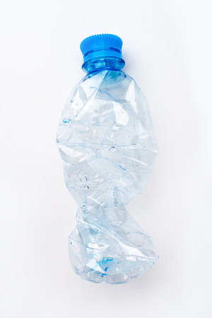 Crumpled empty plastic bottle on a white backgroundの写真素材