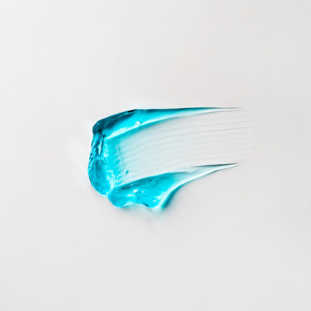 A smear of blue hair gel on a white background