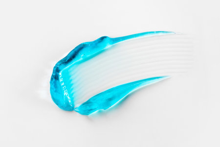 A smear of blue cosmetic hair gel on a white background