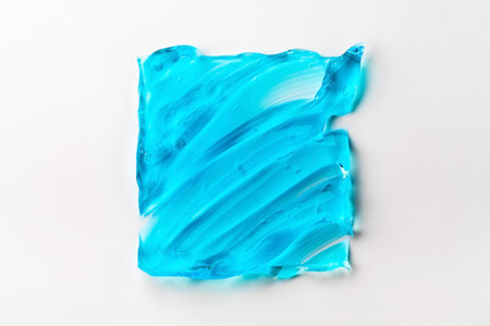 The texture of a blue cosmetic gel in the form of a square on a white backgroundの写真素材