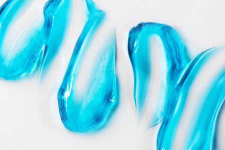 Smears of blue cosmetic gel on a white backgroundの写真素材