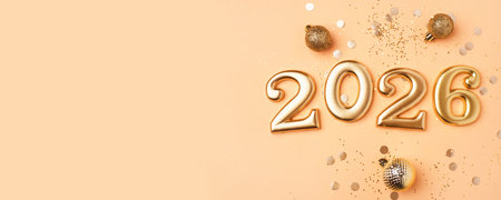 Golden 2026 on a peach color background with confetti and bokeh lights. Top view.