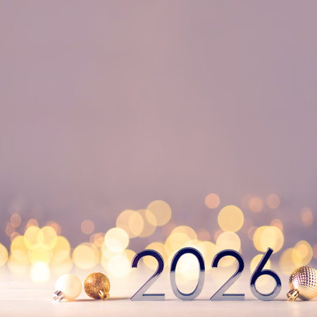 Metal numbers 2026 on a white table with Christmas decorations and bokeh lights. Happy New Year 2026...