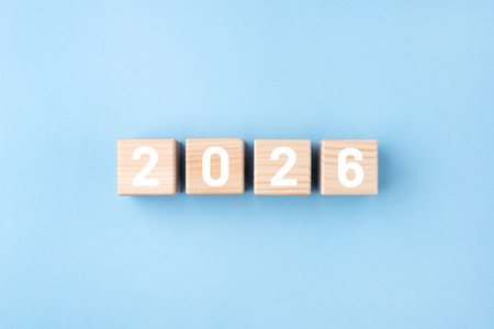 Wooden cubes with numbers of the New Year 2026 on a blue backgroundの写真素材