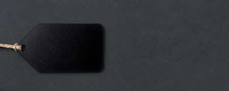 Empty black tag on black background.の写真素材